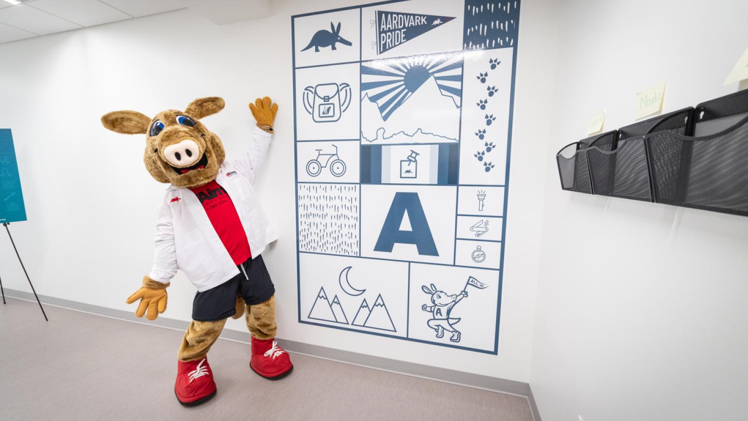 Arty the Aardvark marvels at a mural at the new student health and wellness center