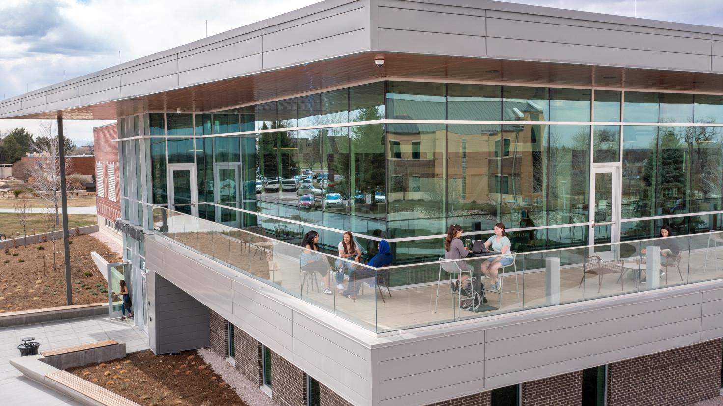Students enjoy the outdoor patio at the Student Commons on the Greeley campus