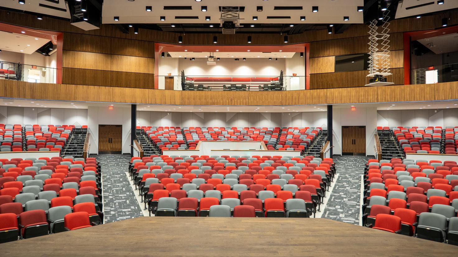 The Aims Welcome Center auditorium showing the main seating area and sky boxes from the vantage point of the stage