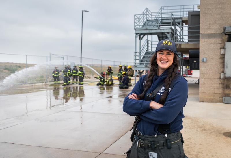 A woman wearing firefighter gear at the 2024 Women in Fire event at Aims