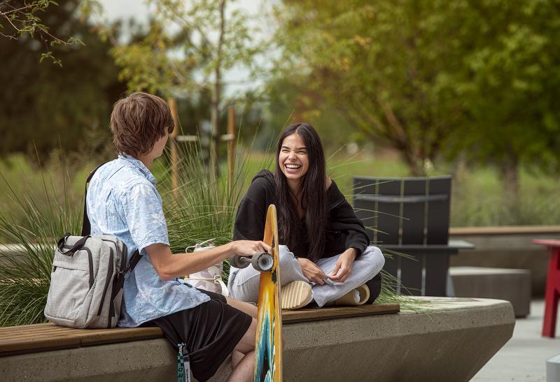 Two students talk outside on the Aims Greeley Campus