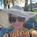 Tiffany in sunglasses and a sun hat on the beach in Cancun.