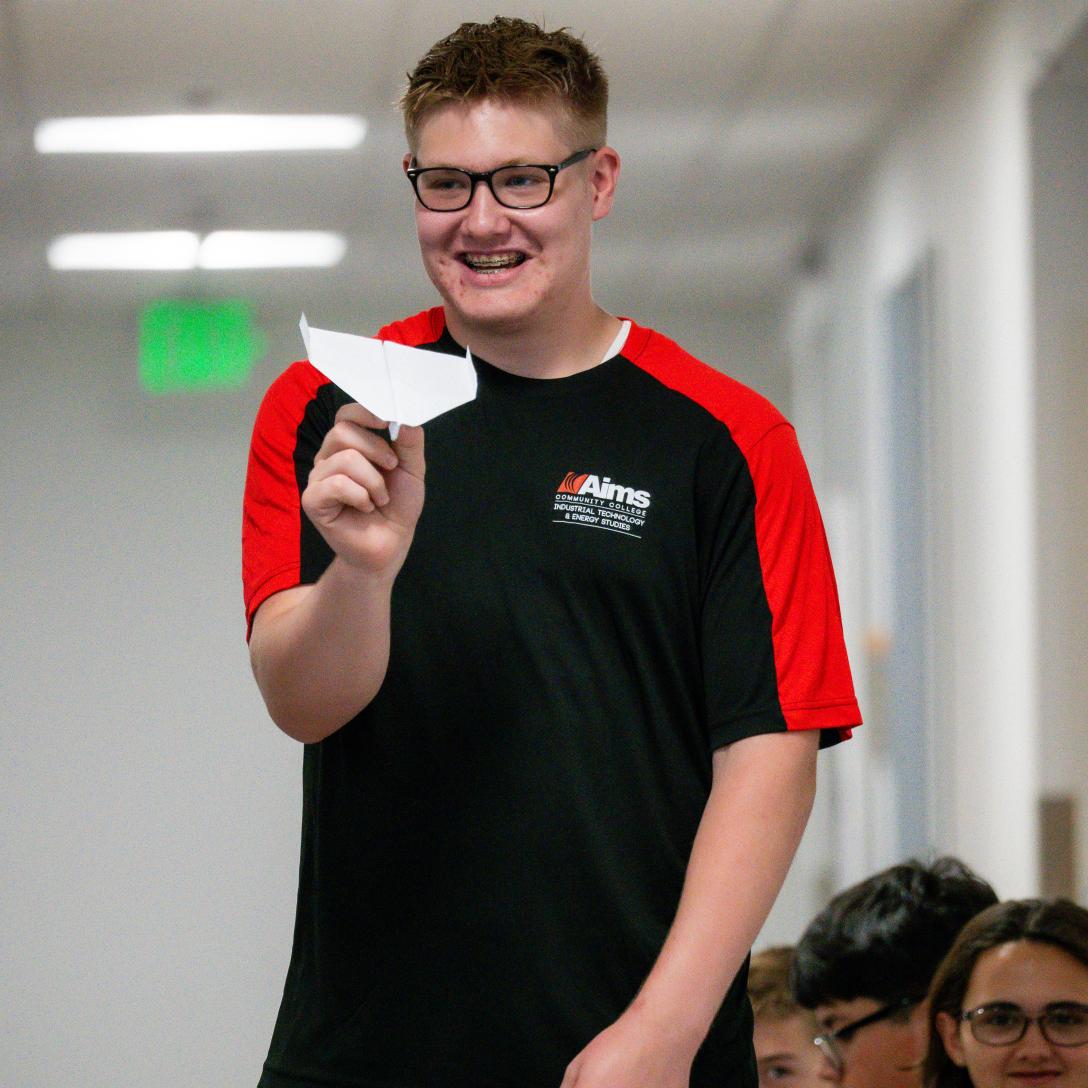 student with paper airplane