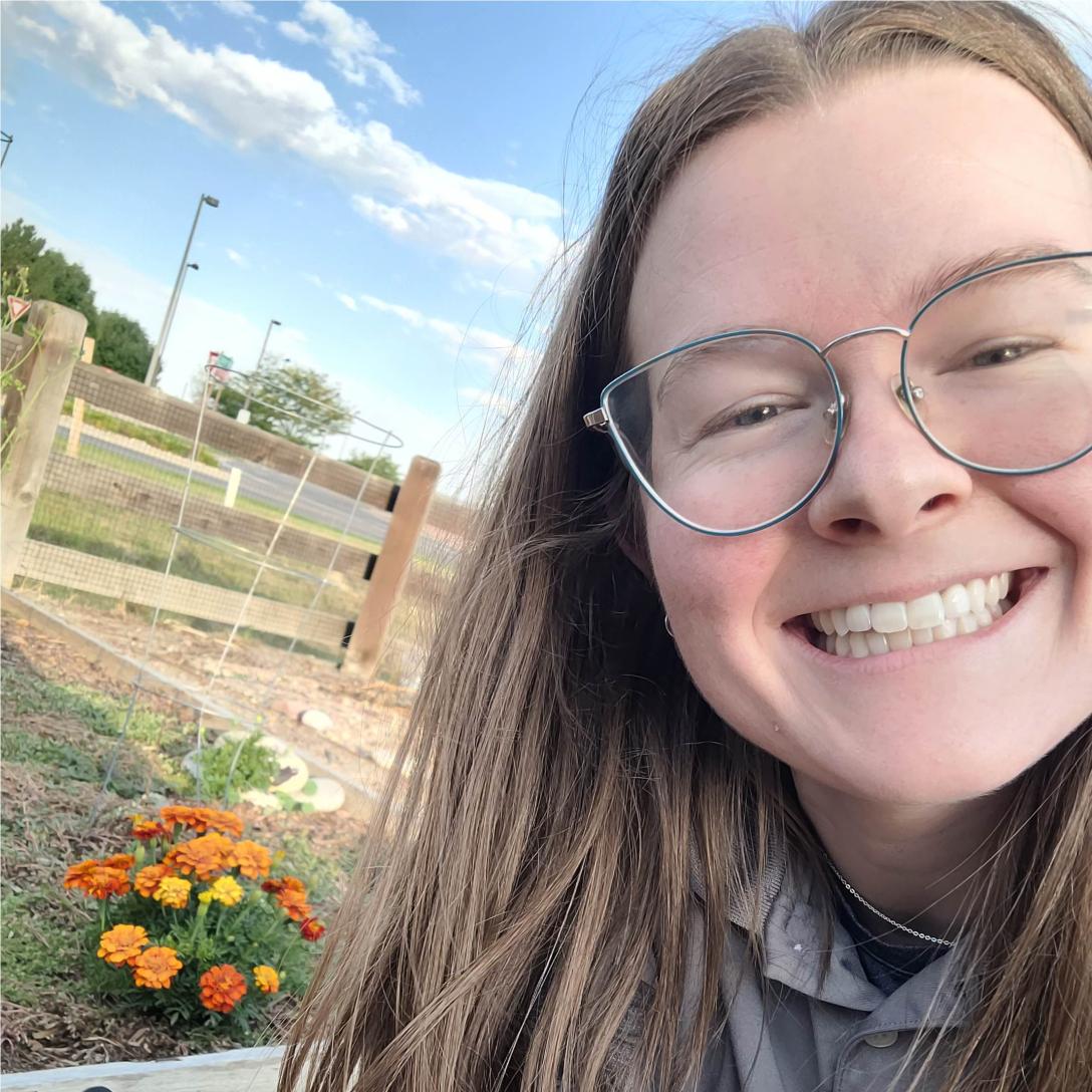 Dakota with marigolds in her garden.
