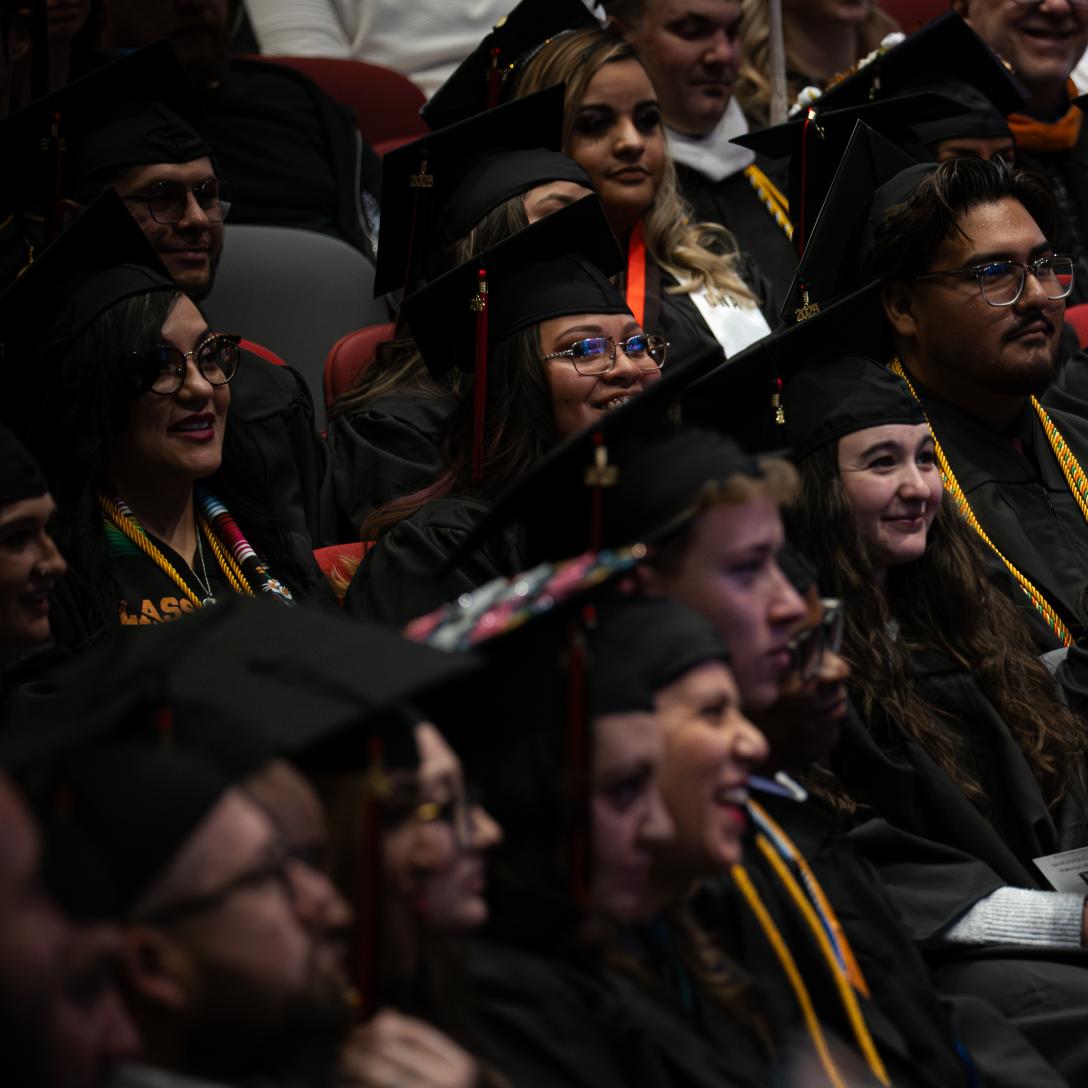 Aims grads sitting at graduation