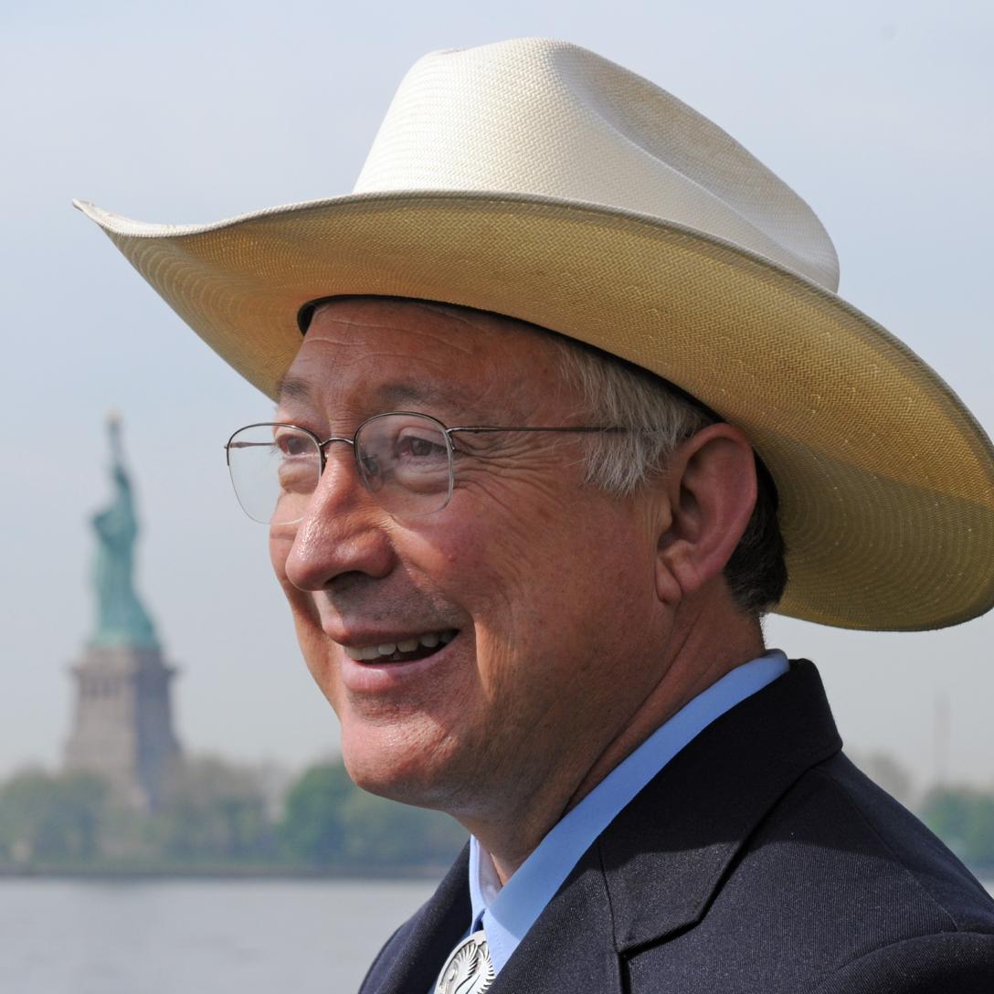 Ken Salazar with Statue of Liberty in the background