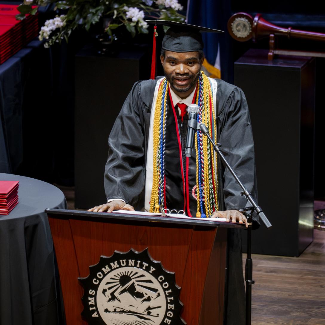 Egide Godonou speaking at behind a podium