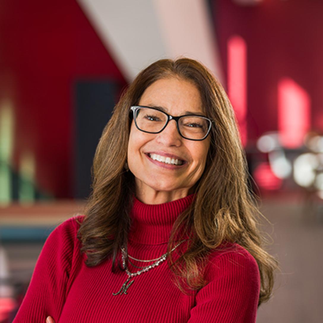 Marizza Plaza smiles and stands for a portrait in the Welcome Center