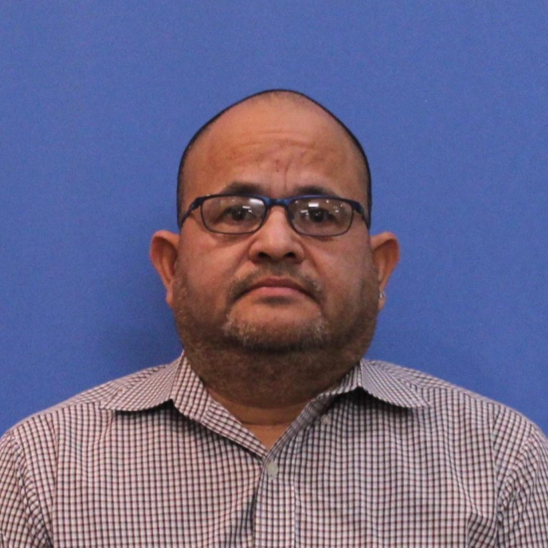 Headshot of Aims biology instructor Oscar Ramirez