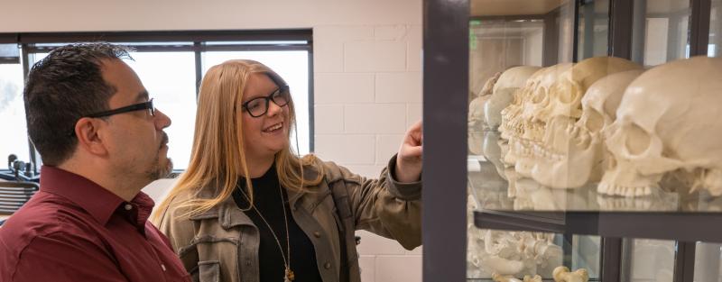 Students in classroom examining skeletal remains