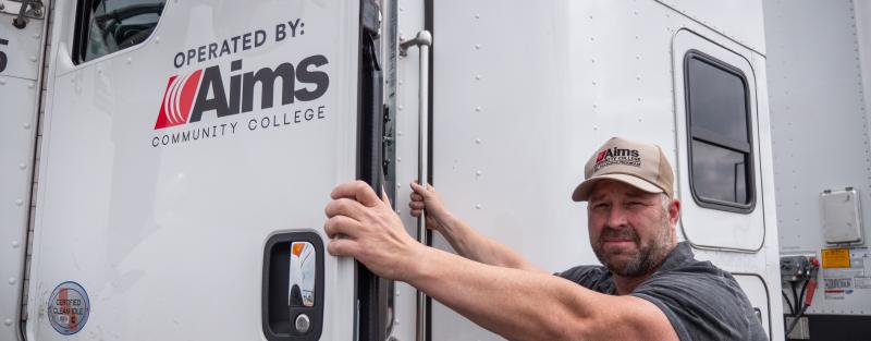 Aims Community College CDL student climbing into truck