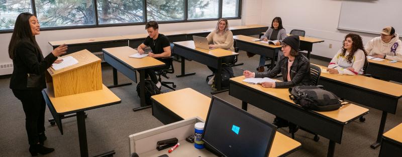 An Aims instructor engaging with students in a classroom