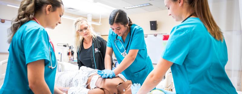 Aims Acute Care Nurse Aide Certificate students practicing in a lab setting
