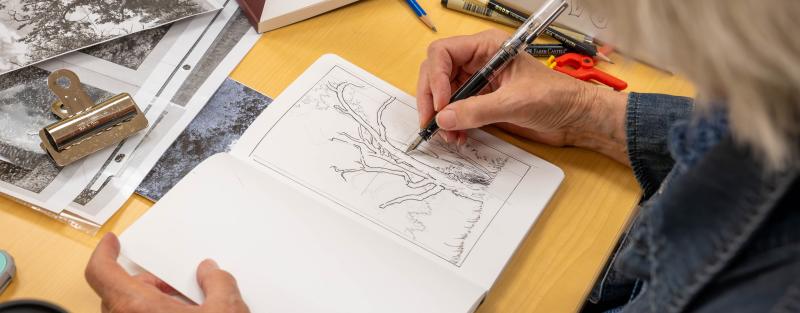 Continuing Education personal enrichment student drawing in a notebook