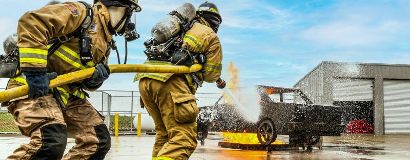 Aims Community College Fire Science students extinguishing a vehicle fire