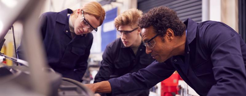 Aims automobile service technology students working on a car