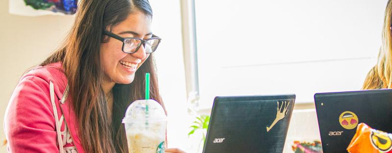 A student works on school assignments on her laptop.