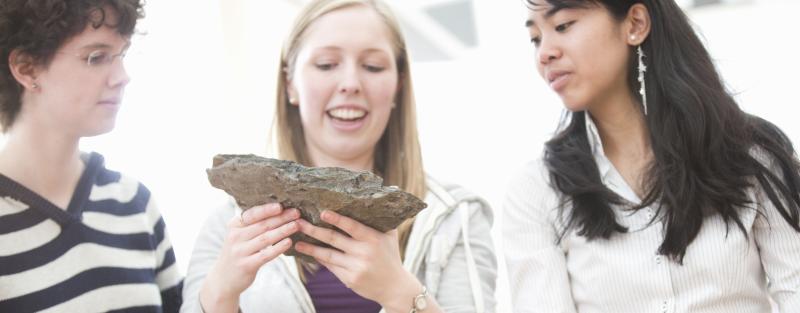 Students in geology lab examining a rock sample