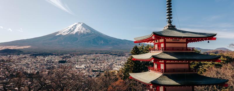 A breathtaking view of Mount Fuji alongside the iconic Chureito Pagoda under a clear sky.
