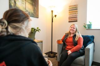 An Aims counselor talks with a student during a counseling session