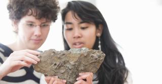 Students in geology lab examining a rock sample