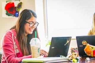 A student works on school assignments on her laptop.