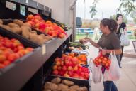 Farms to Families Food Truck with student choosing veggies