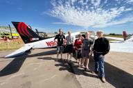 Group standing by airplane at Aviation Day