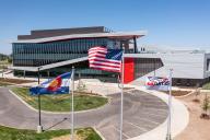 The Colorado, United States and Aims Community College flags fly in front of the Welcome Center