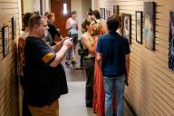 People looking at pictures and paintings at Aims art show