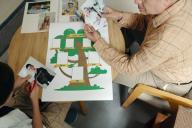 boy and grandfather making family tree at a table