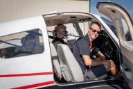 People smiling from Aims plane at Aviation Day