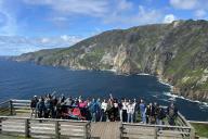 Study Abroad Group on Dock with water and hill