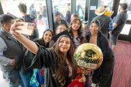 Selfie of Graduate with balloon and family and friends