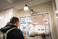 A student walking into the door of the Aims Disability Access Services Office