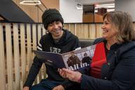 Admission Councilor showing student information in a book