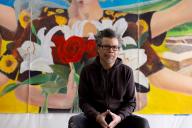 Frank Garza in front of his art