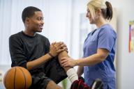 Doctor examining a student's knee