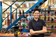 Person posing in front of tools and equipment