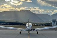 Airplane in front of mountain at sunset