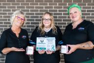 People holding narcan boxes and drug recovery information