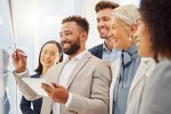 Group of Employees one writing on a white board