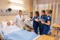 Nursing students and instructor in mock hosptial room