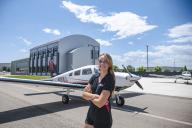 Samantha Walsh with plane and Aims Flight Training Center in the background