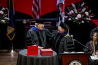  Lyle Achziger and  Marilyn Schock, Chair of the Aims Board of Trustees on the Commencement Stage