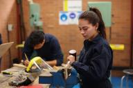 Two students at workbench woodworking