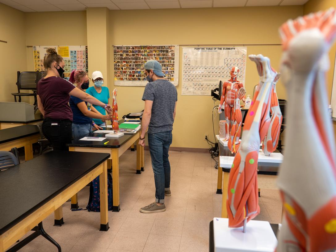 Aims biology students in a lab on the Loveland Campus