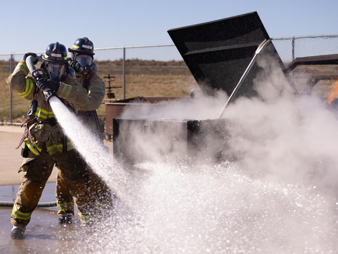Students using a fire hose