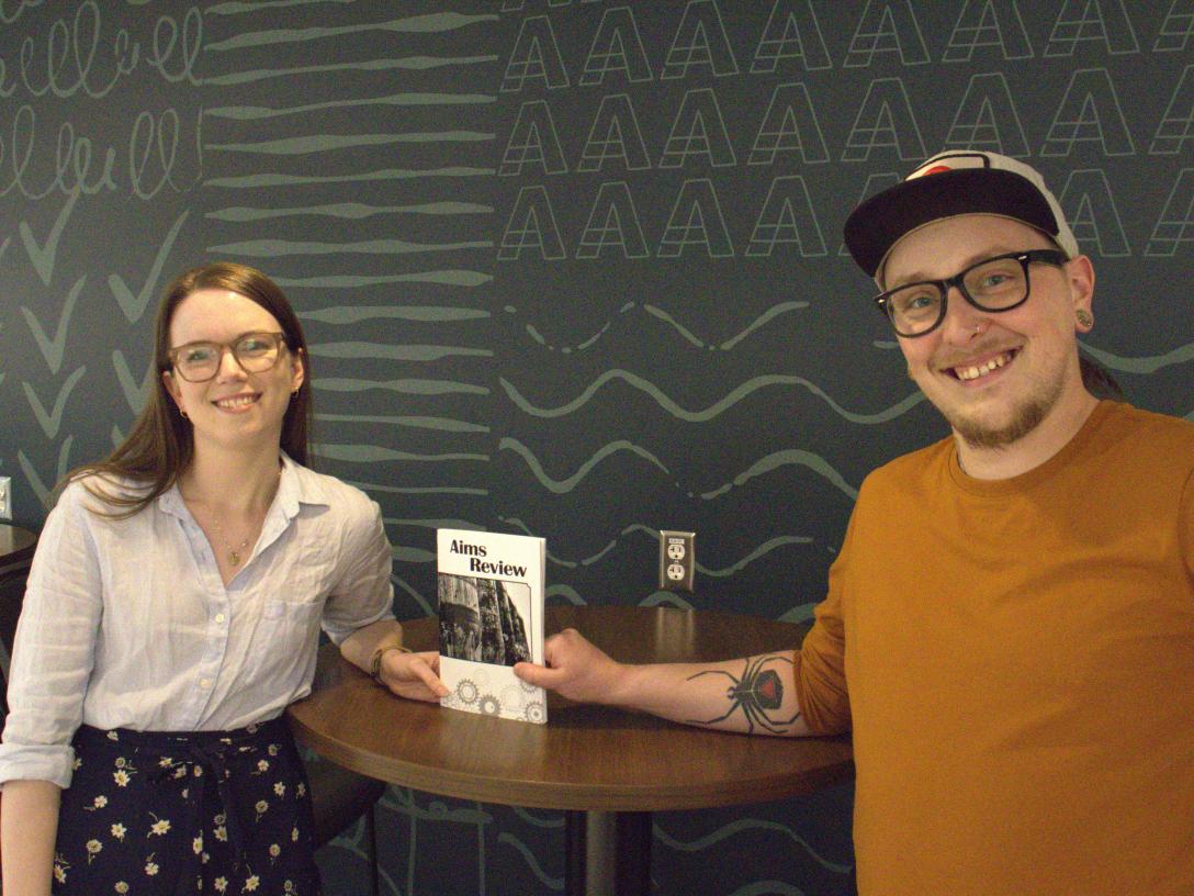 Mariah Crawford and Sundance Hollingsworth with a copy of the Aims Review