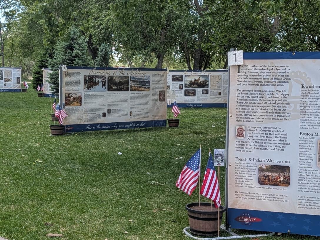 Large signs on lawn with war history. 